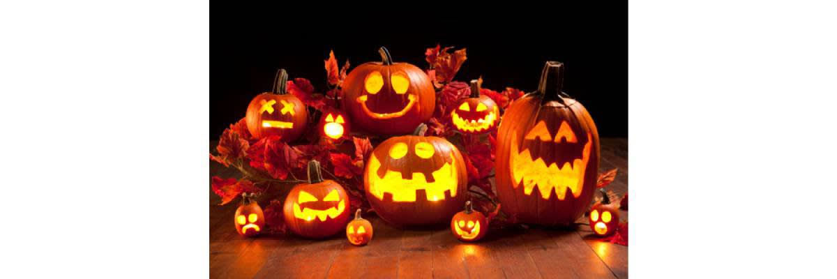 Jack-o-Lanterns lit up around leaves