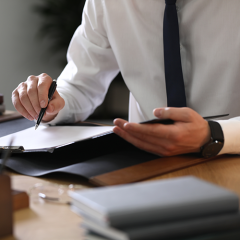 Male lawyer working at table in office, closeup
