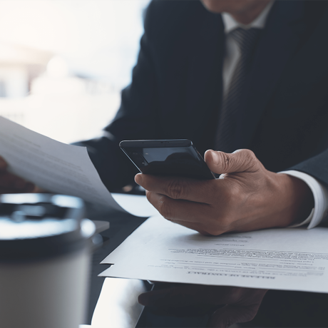 Closeup businessman reading before signing business contract documents