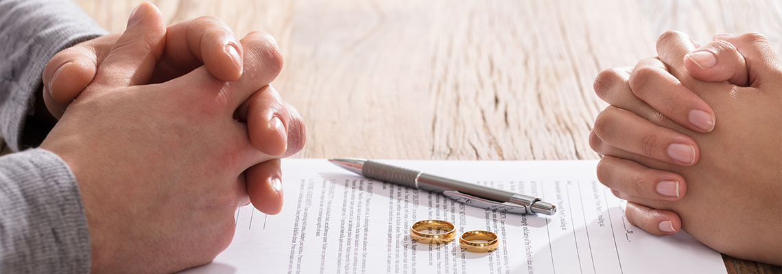 Couple's Hand On Divorce Agreement