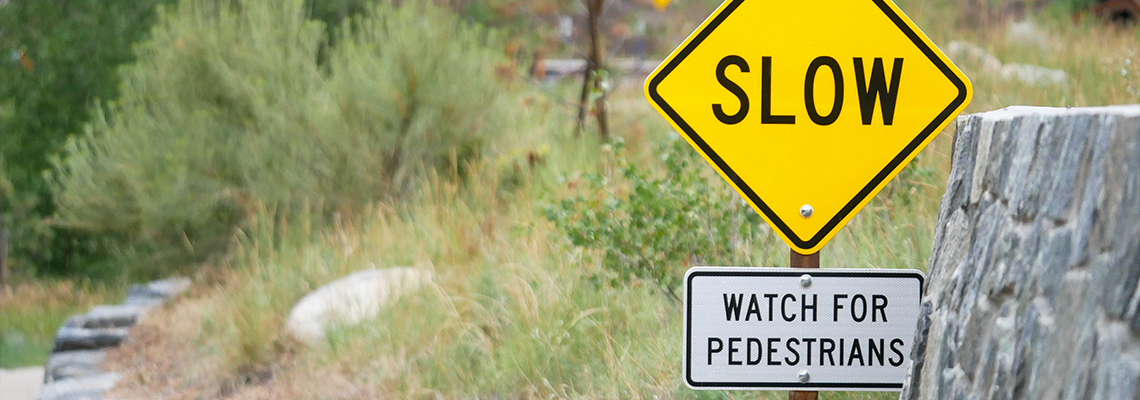 Sign that reads slow, watch for pedestrians