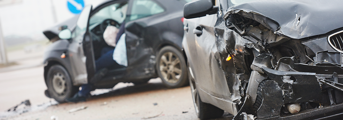 Two badly damaged vehicles on road after accident