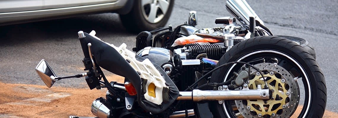 Motorcycle on its side in the road