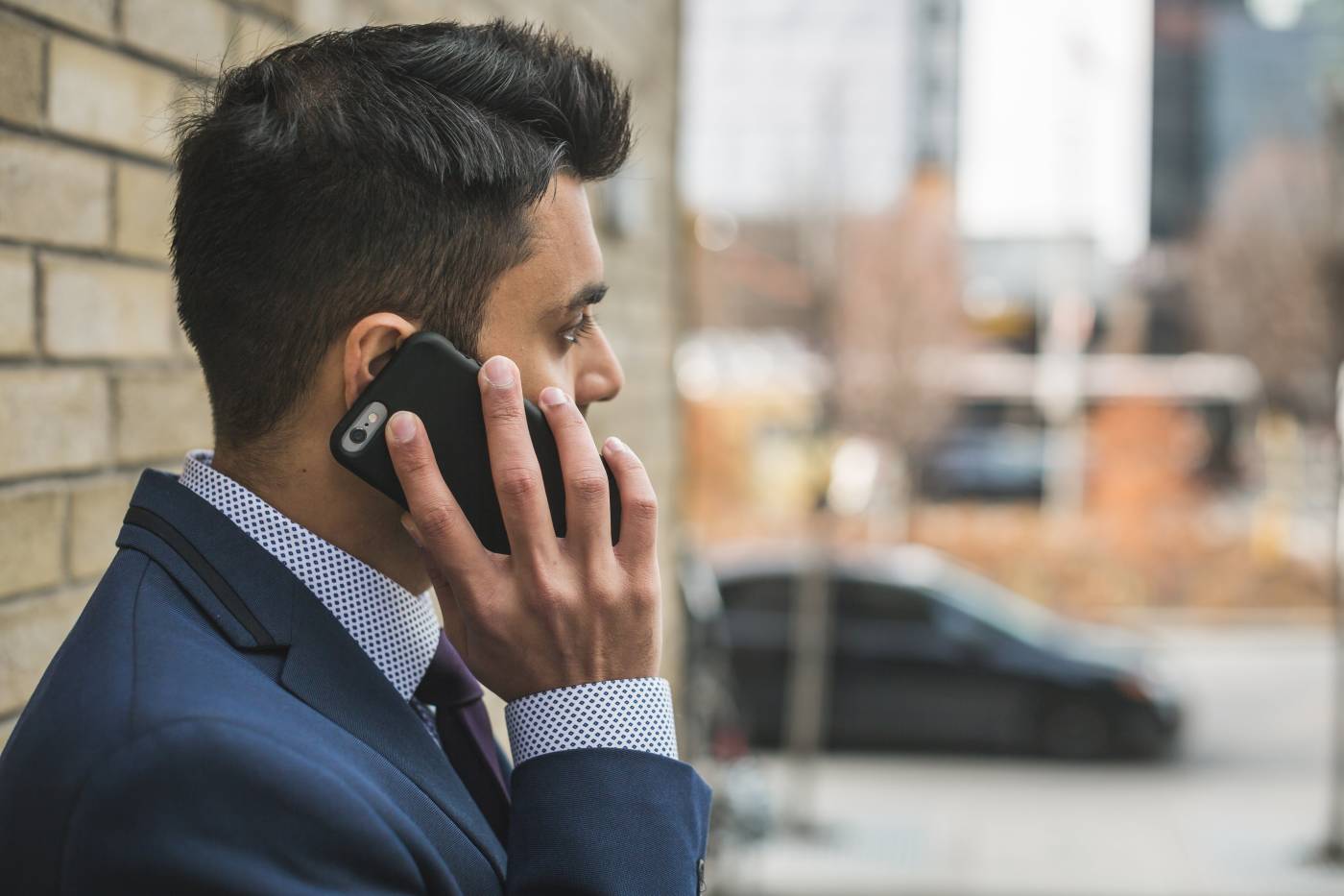 Man in blue suit on phone
