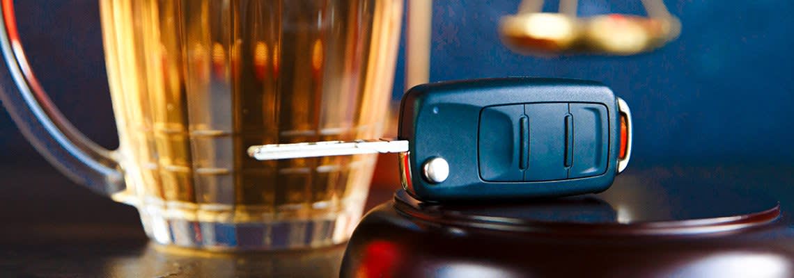 A car key sits near a pitcher of beer