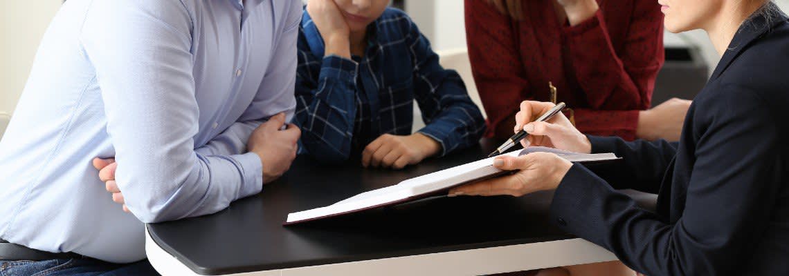 Woman going over a document with three people