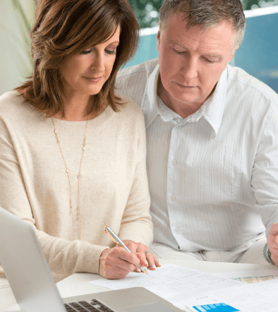 Married Couple Signing a Document